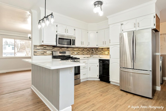 kitchen with appliances with stainless steel finishes, a sink, white cabinetry, and light wood-style floors