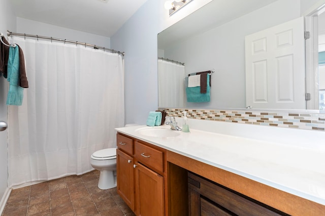 bathroom featuring backsplash, vanity, and toilet