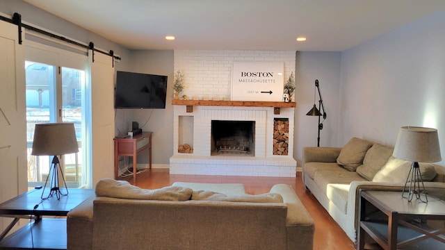 322 Arlington Ave, Naperville, IL 60565 - living area with a fireplace, wood finished floors, a barn door, plenty of natural light, and recessed lighting