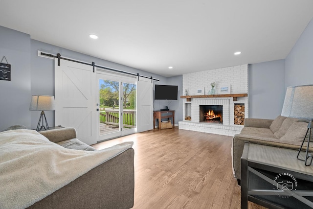 322 Arlington Ave, Naperville, IL 60565 - living area featuring a barn door, wood finished floors, recessed lighting, and a brick fireplace