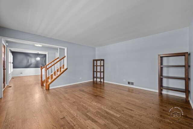 322 Arlington Ave, Naperville, IL 60565 - unfurnished room with wood finished floors, baseboards, and stairway