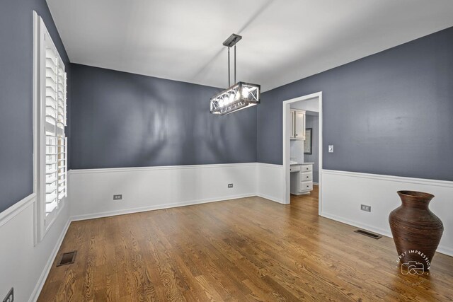 322 Arlington Ave, Naperville, IL 60565 - unfurnished dining area with wood finished floors and baseboards