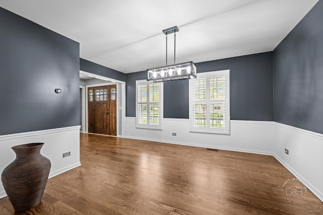 322 Arlington Ave, Naperville, IL 60565 - unfurnished dining area featuring wood finished floors, plenty of natural light, and baseboards