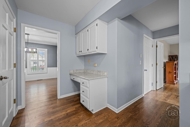 322 Arlington Ave, Naperville, IL 60565 - kitchen with dark wood finished floors, white cabinetry, baseboards, and light stone countertops