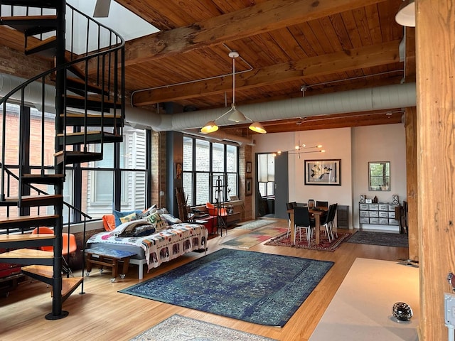 interior space with stairs, beamed ceiling, wood finished floors, and wood ceiling