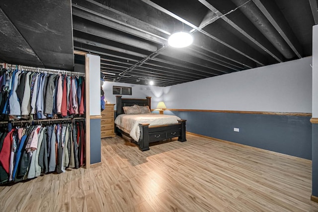 bedroom featuring light wood-type flooring and a closet