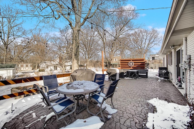 yard layered in snow featuring a patio