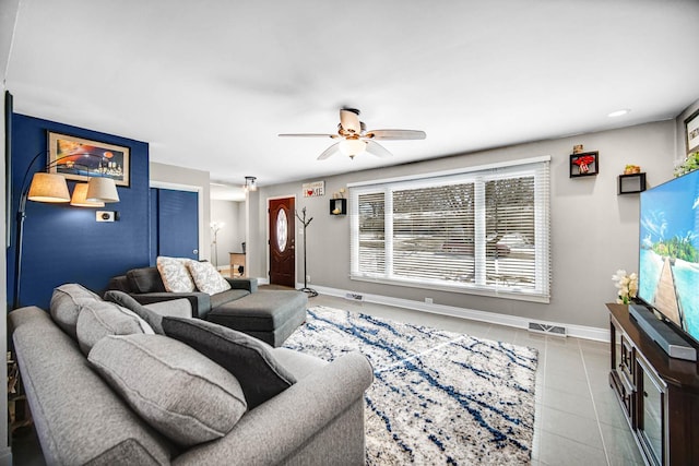 tiled living room with ceiling fan, visible vents, and baseboards