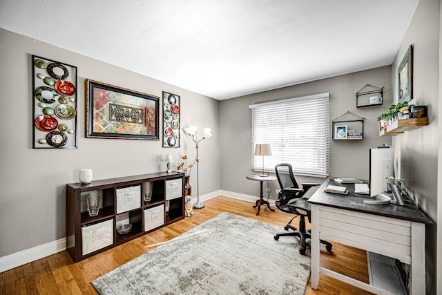 office area with baseboards and wood finished floors