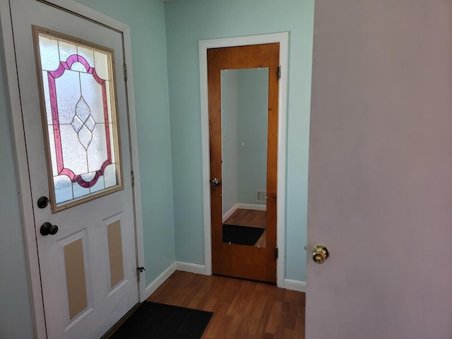 doorway to outside with light wood-type flooring and baseboards