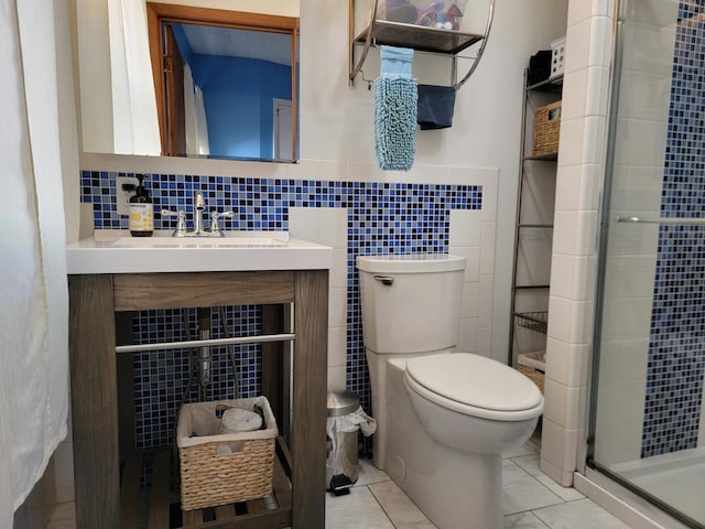 full bath with a stall shower, tile walls, toilet, and vanity