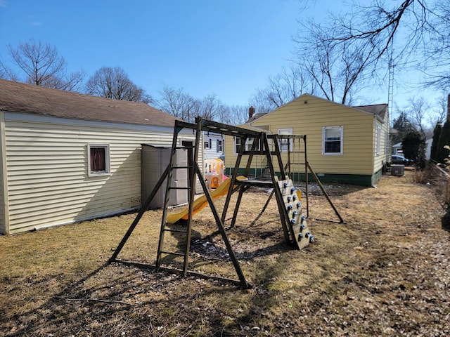 back of house featuring crawl space and a playground