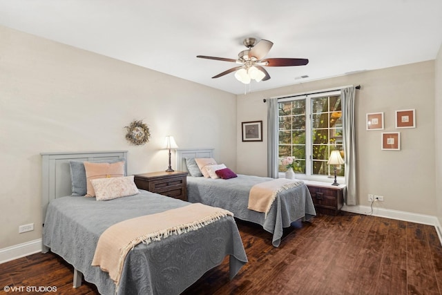 bedroom with ceiling fan, baseboards, and dark wood-style flooring