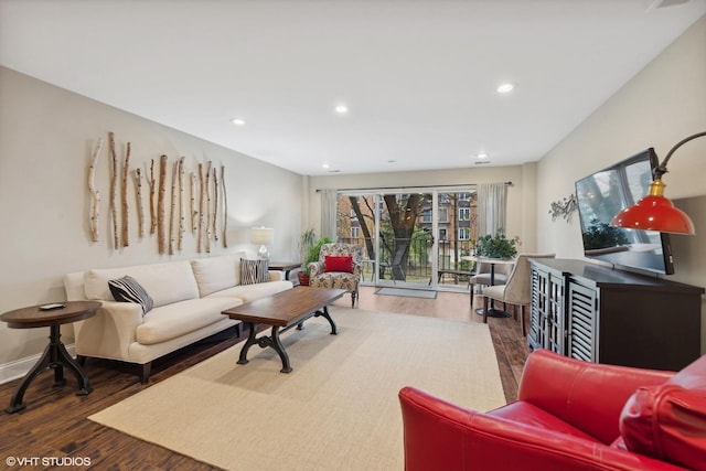 living area with baseboards, dark wood finished floors, and recessed lighting