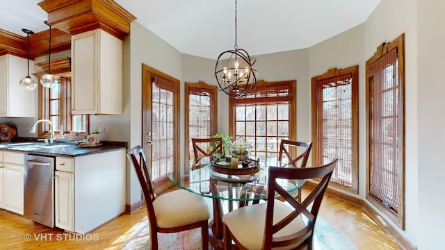 dining area featuring an inviting chandelier, baseboards, and light wood-style floors