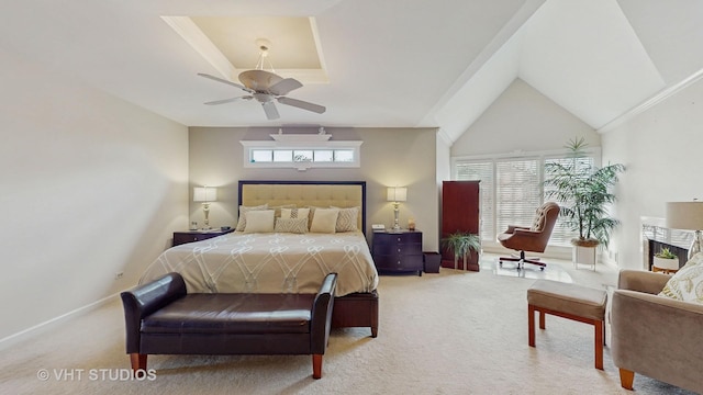 bedroom with lofted ceiling, ceiling fan, baseboards, and light colored carpet