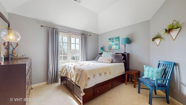 bedroom with lofted ceiling, visible vents, baseboards, and light colored carpet