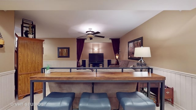 office featuring ceiling fan and wainscoting