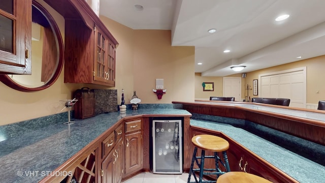 bar featuring wine cooler, bar, and recessed lighting