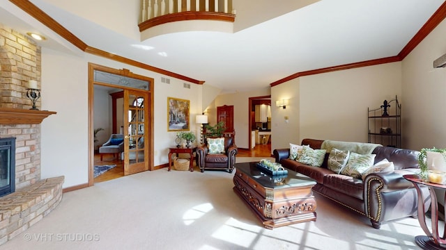 living room featuring baseboards, visible vents, crown molding, carpet flooring, and a fireplace