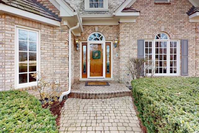 property entrance featuring brick siding