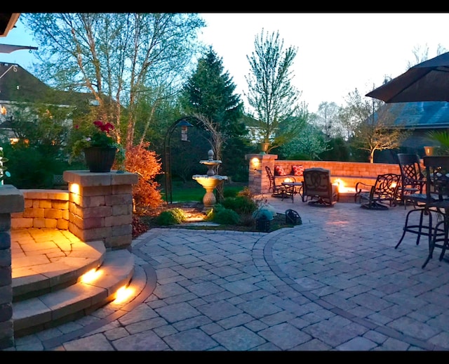 view of patio featuring an outdoor fire pit and fence