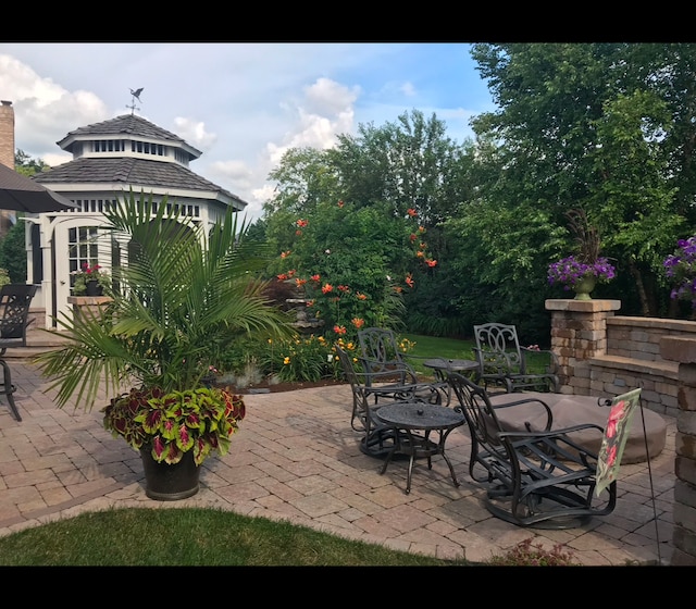 view of patio / terrace with outdoor dining space and a gazebo