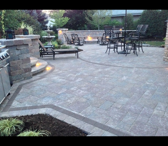 view of patio / terrace with an outdoor fire pit