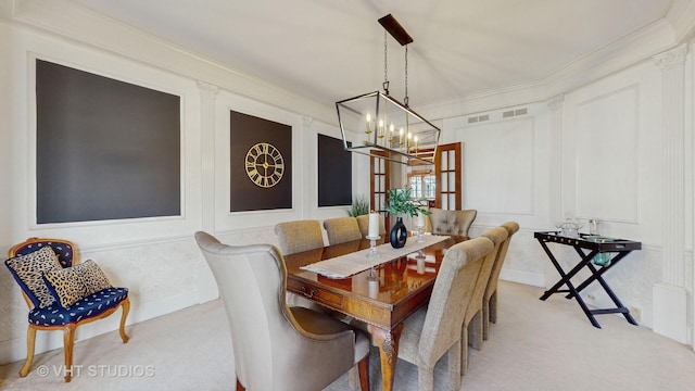 dining space with crown molding, a notable chandelier, carpet flooring, and a decorative wall