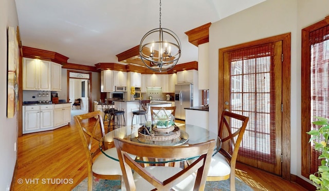 dining room with a chandelier and light wood-style floors