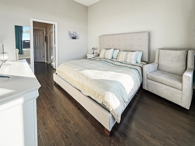 bedroom with dark wood-style floors