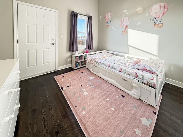 bedroom featuring dark wood-type flooring and baseboards