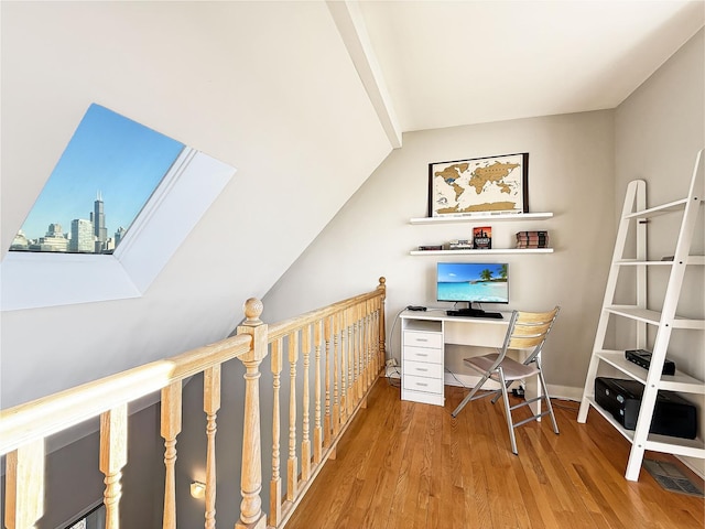 office area with a view of city, baseboards, and wood finished floors