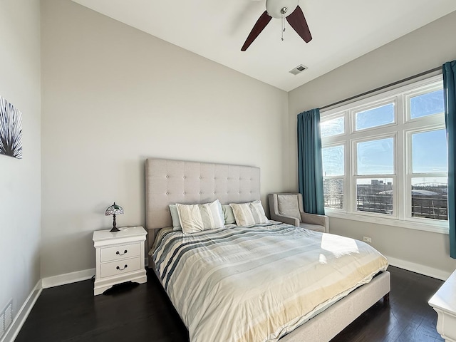 bedroom featuring dark wood-style flooring, lofted ceiling, visible vents, ceiling fan, and baseboards