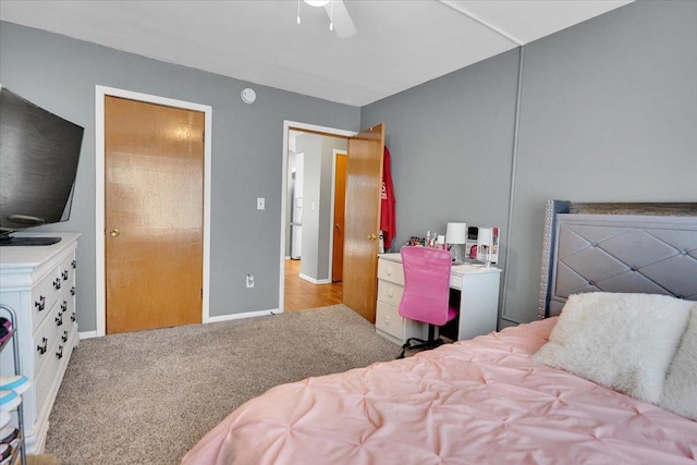 bedroom with baseboards, a ceiling fan, and light colored carpet