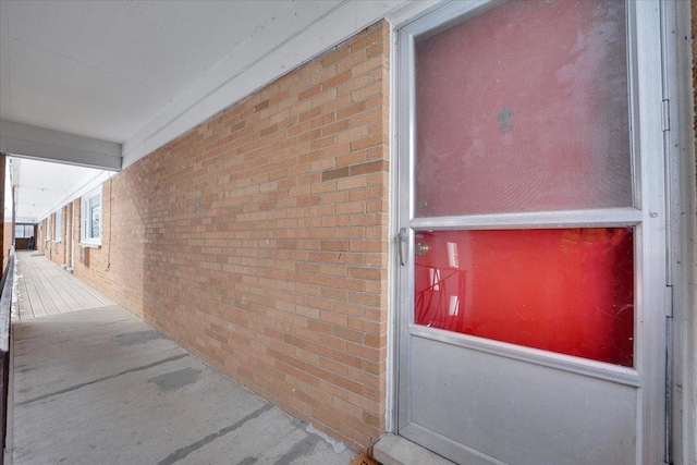 property entrance featuring brick siding