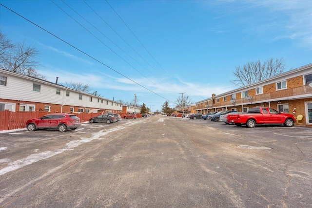 uncovered parking lot with a residential view