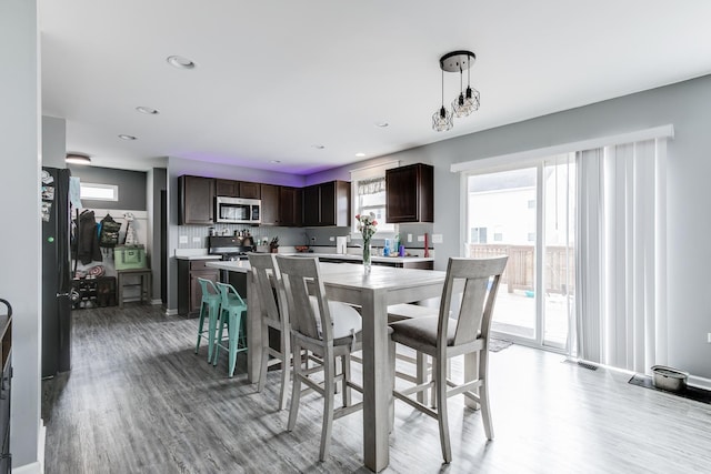 dining area with recessed lighting and light wood-style floors