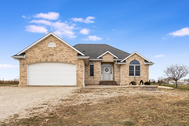 ranch-style house featuring brick siding, driveway, and an attached garage