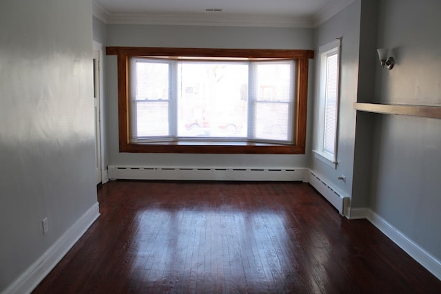 unfurnished room with baseboard heating, dark wood-style flooring, crown molding, and baseboards