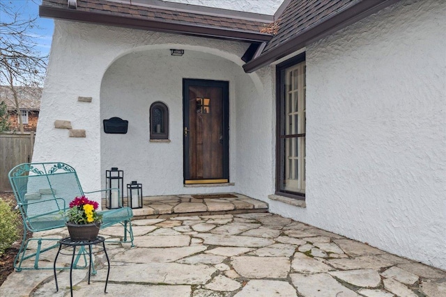 property entrance featuring stucco siding