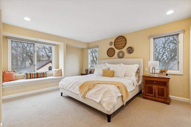 bedroom featuring light carpet, baseboards, and recessed lighting