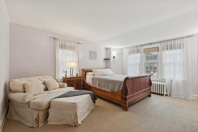 bedroom with multiple windows, radiator heating unit, carpet floors, and crown molding