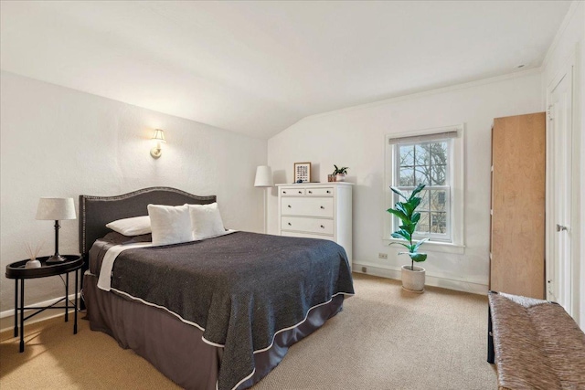 bedroom with vaulted ceiling, crown molding, carpet, and baseboards
