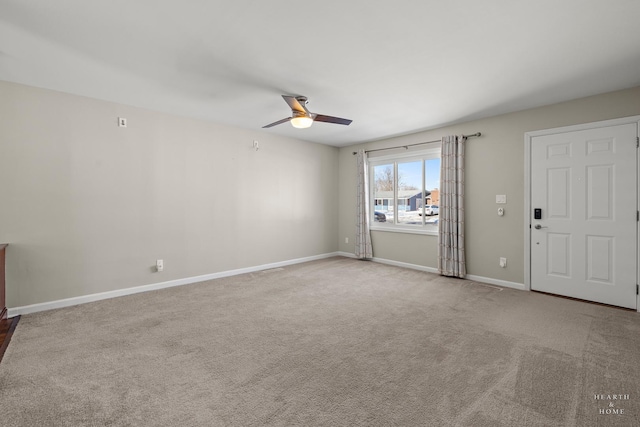 unfurnished living room with carpet, a ceiling fan, and baseboards