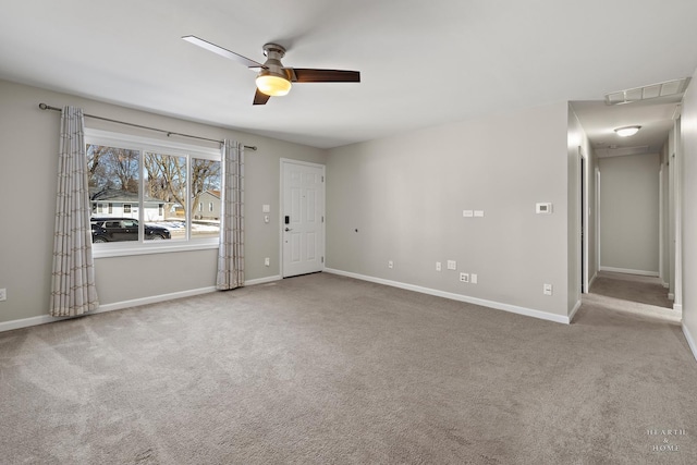 spare room featuring baseboards, visible vents, ceiling fan, and light colored carpet