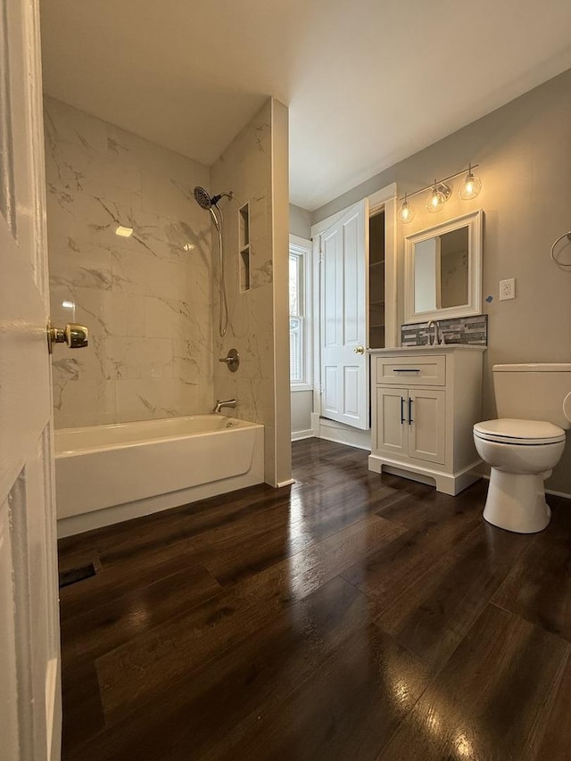 bathroom with shower / bath combination, vanity, toilet, and wood finished floors