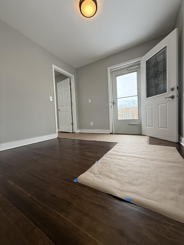 interior space featuring baseboards and wood finished floors