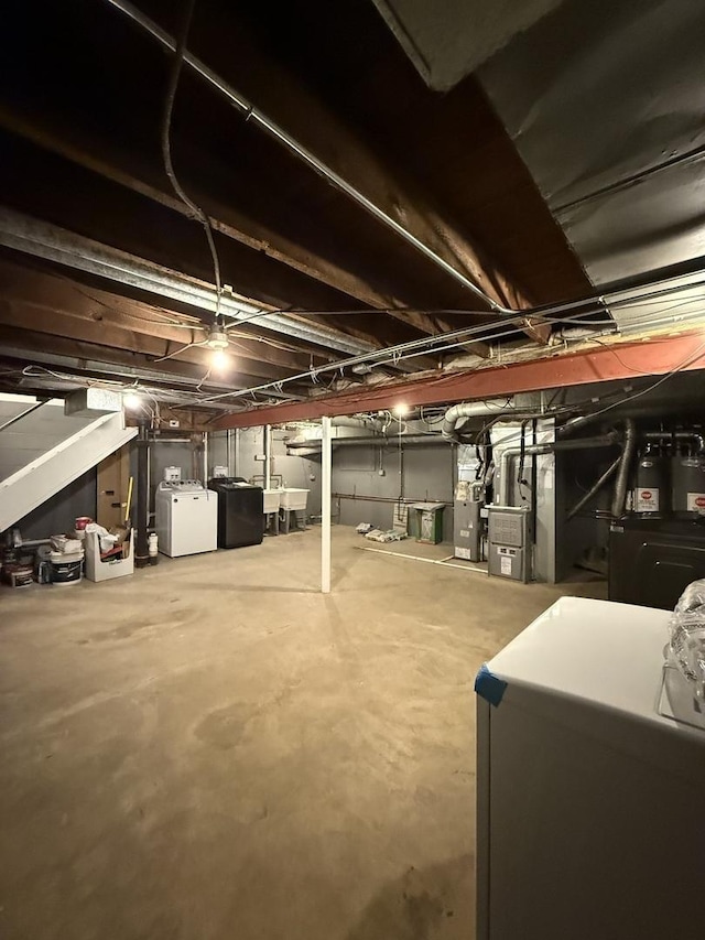 unfinished basement with washing machine and clothes dryer