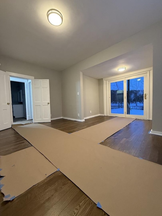 interior space featuring baseboards and wood finished floors